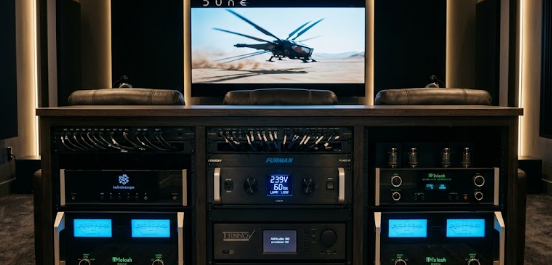 A premium home theater rack featuring a glowing rack-mounted unit used for symmetrical power conditioning.