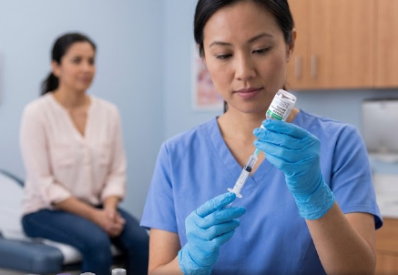 A healthcare professional preparing typhoid vaccines for administration to a patient.
