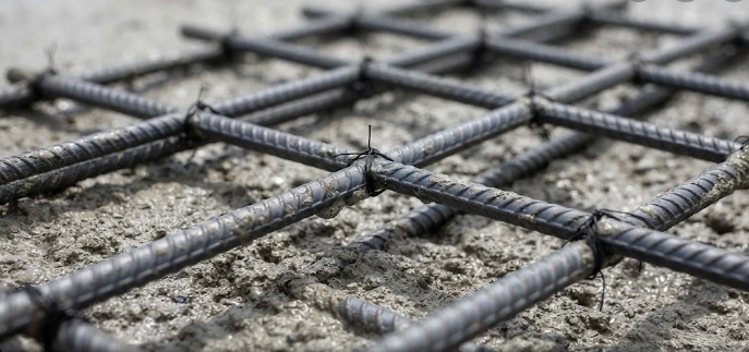 A clear engineering photo illustrating the synergy of steel and concrete with embedded rebar.